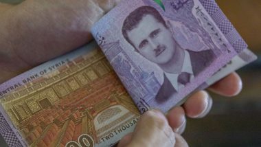 Report: Syrian Central Bank Devalues Local Currency by Nearly 50%