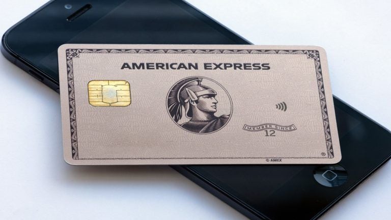 Image of an American Express card on top of a phone.